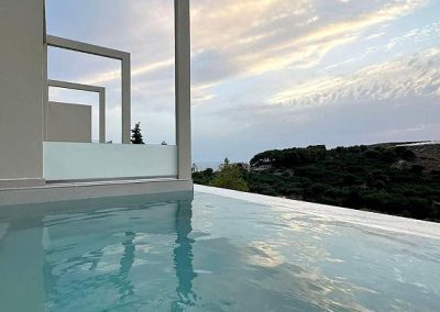 Private balcony with outdoor chairs and scenic Zakynthos landscape view, Myzith Luxury Suites, Keri, Zakynthos, Greece.