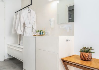 Minimal suite sleeping area with natural light and modern furnishings, Myzith Luxury Suites, Keri, Zakynthos, Greece.