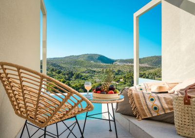 Private balcony with outdoor chairs and scenic Zakynthos landscape view, Myzith Luxury Suites, Keri, Zakynthos, Greece.