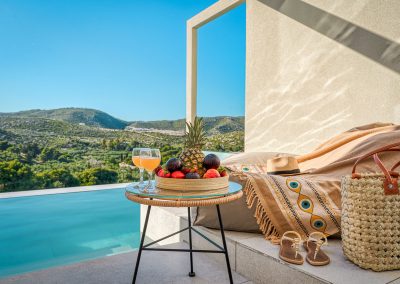 Private balcony with outdoor chairs and scenic Zakynthos landscape view, Myzith Luxury Suites, Keri, Zakynthos, Greece.