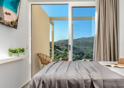 Private balcony with outdoor chairs and scenic Zakynthos landscape view, Myzith Luxury Suites, Keri, Zakynthos, Greece.