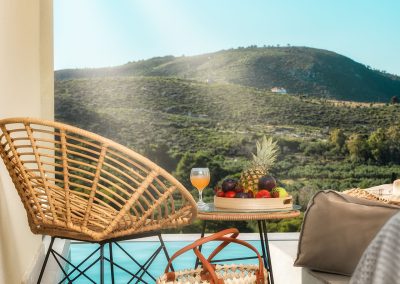 Private balcony with outdoor chairs and scenic Zakynthos landscape view, Myzith Luxury Suites, Keri, Zakynthos, Greece.